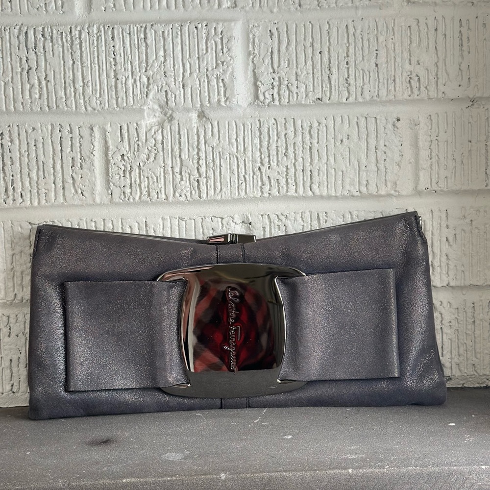Salvatore Ferragamo pewter grey metallic bow clutch , used, like new.  No strap